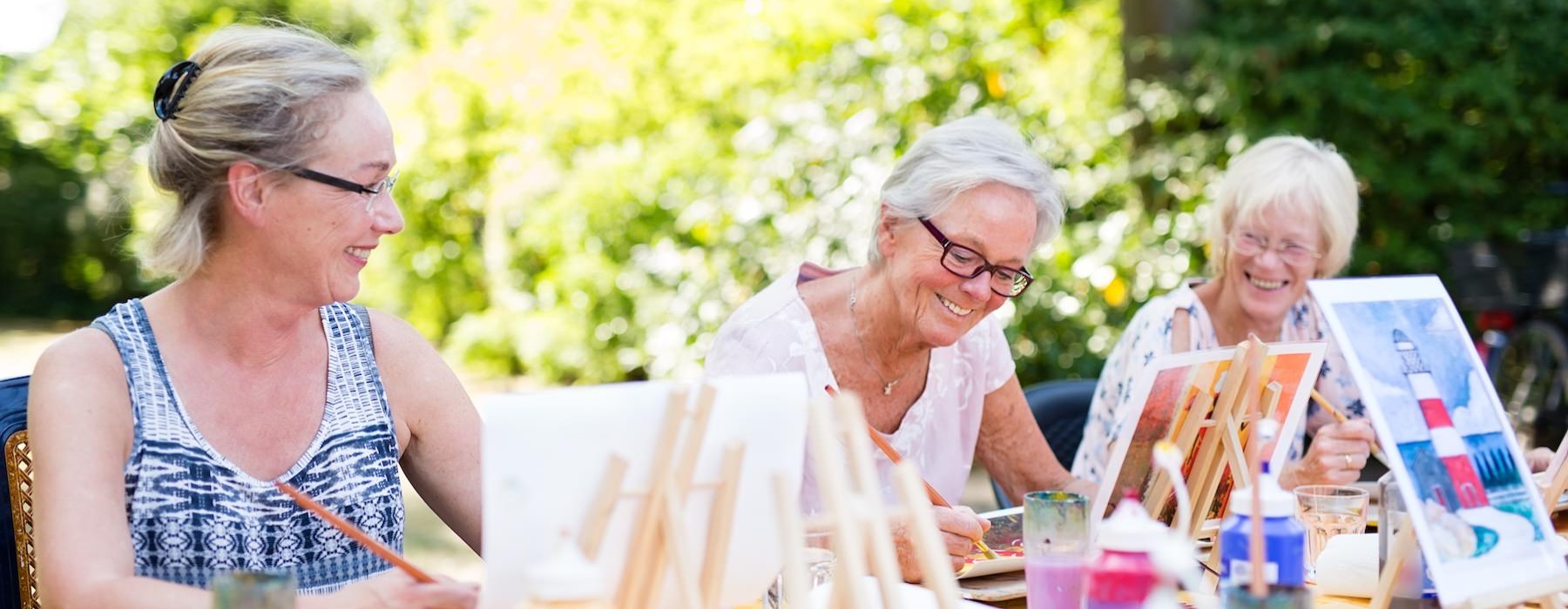a group of people painting outside